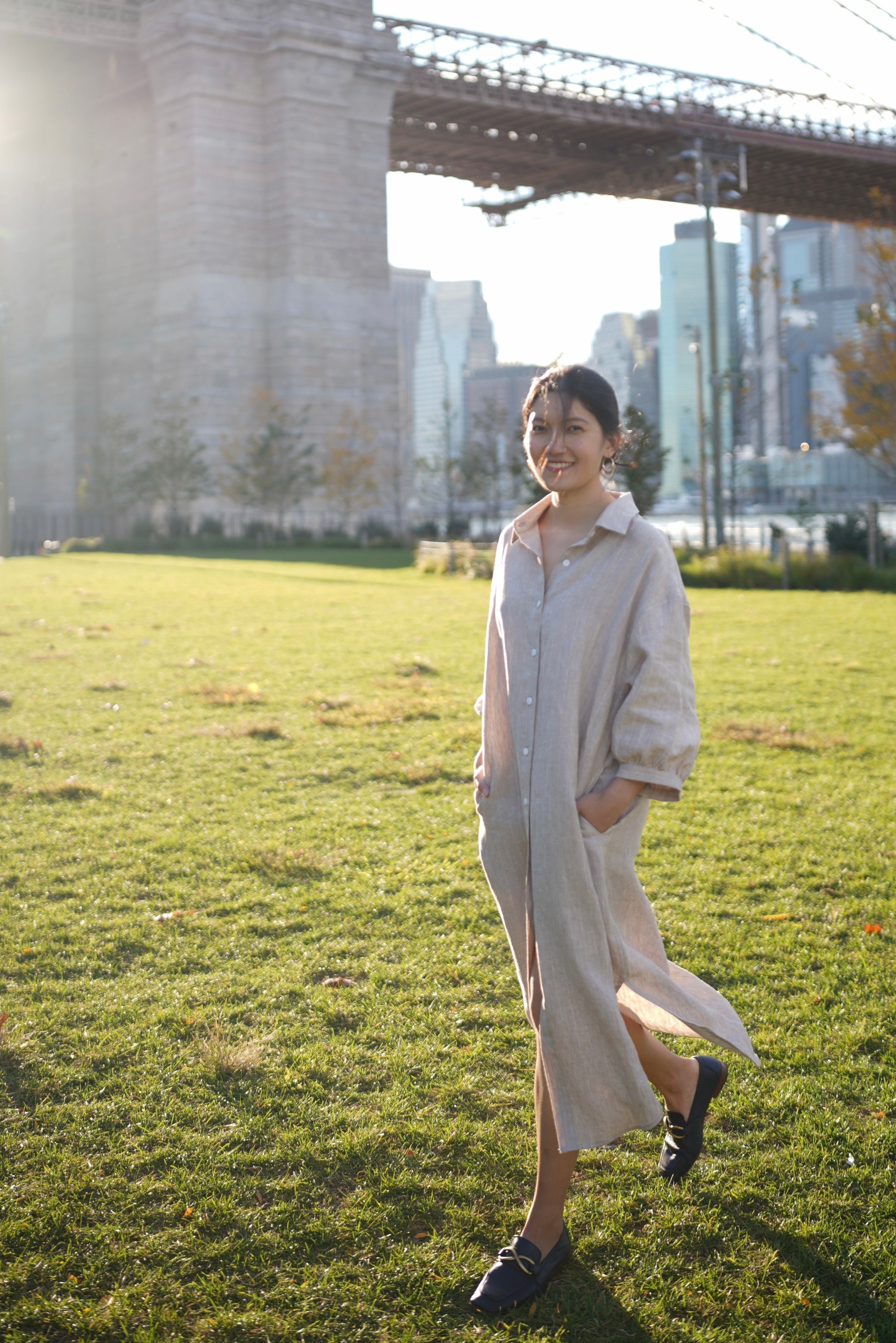 a model walking on the lawn in a beige puff sleeve dress