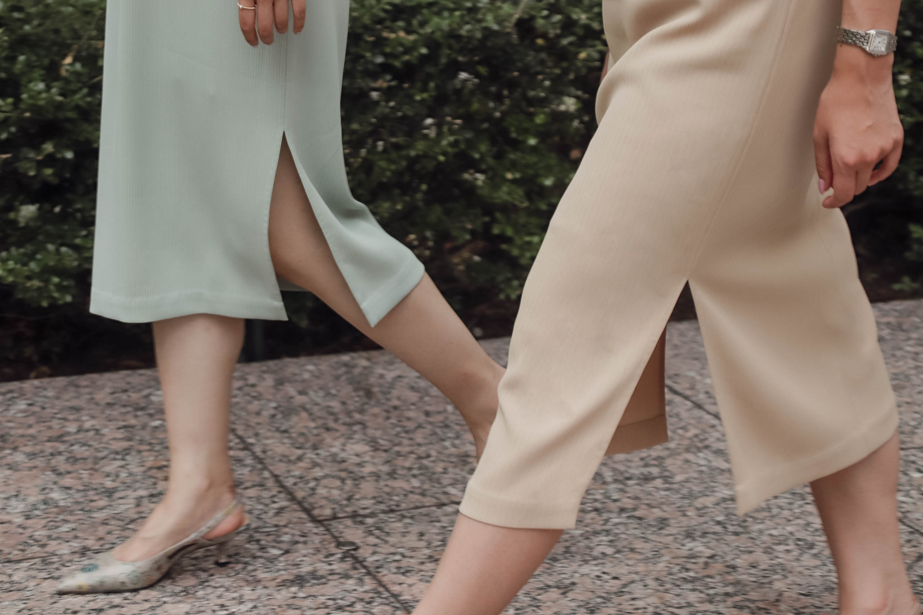 two models walking in mid-sleeve qipaos