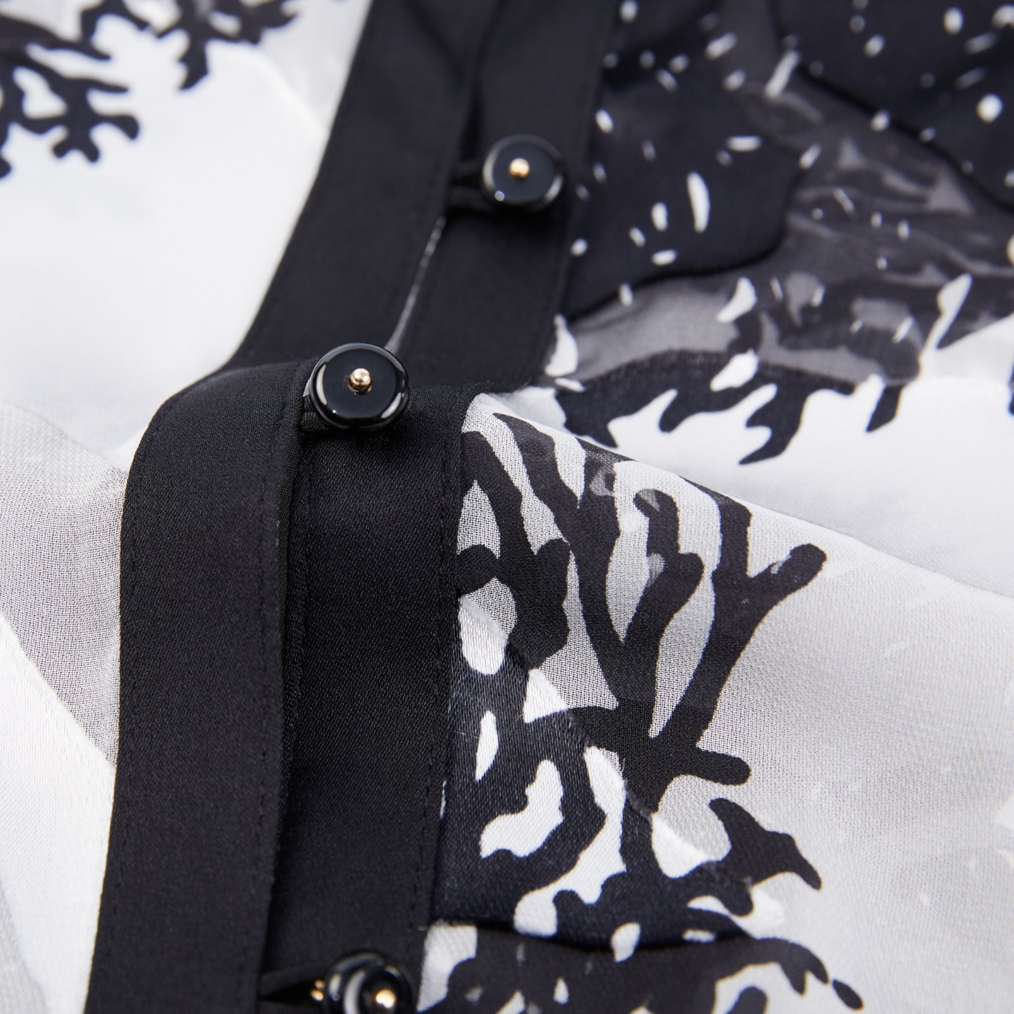 closeup of the button detail on a burnout silk shirt