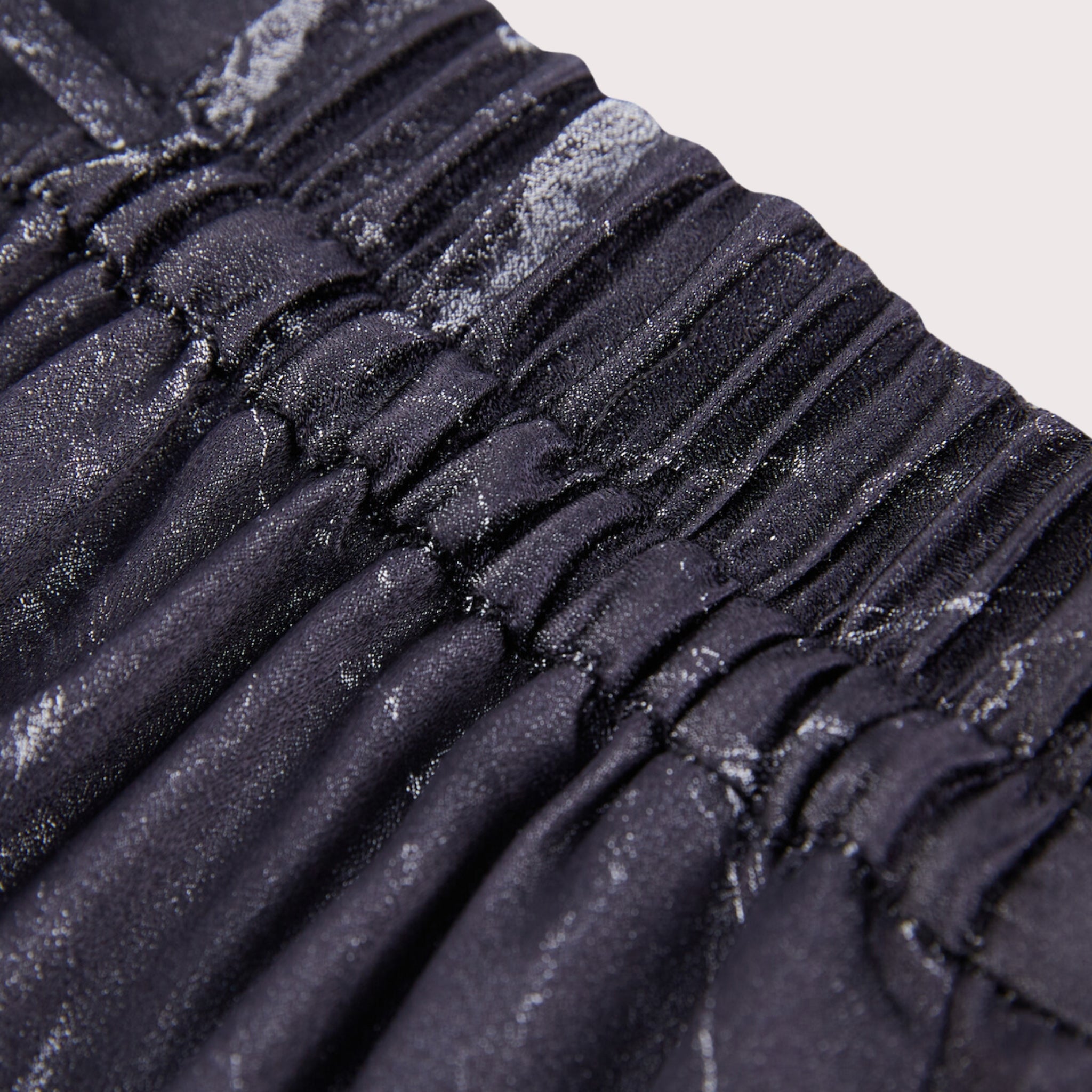 closeup of the waistband detail on silk wide leg pants