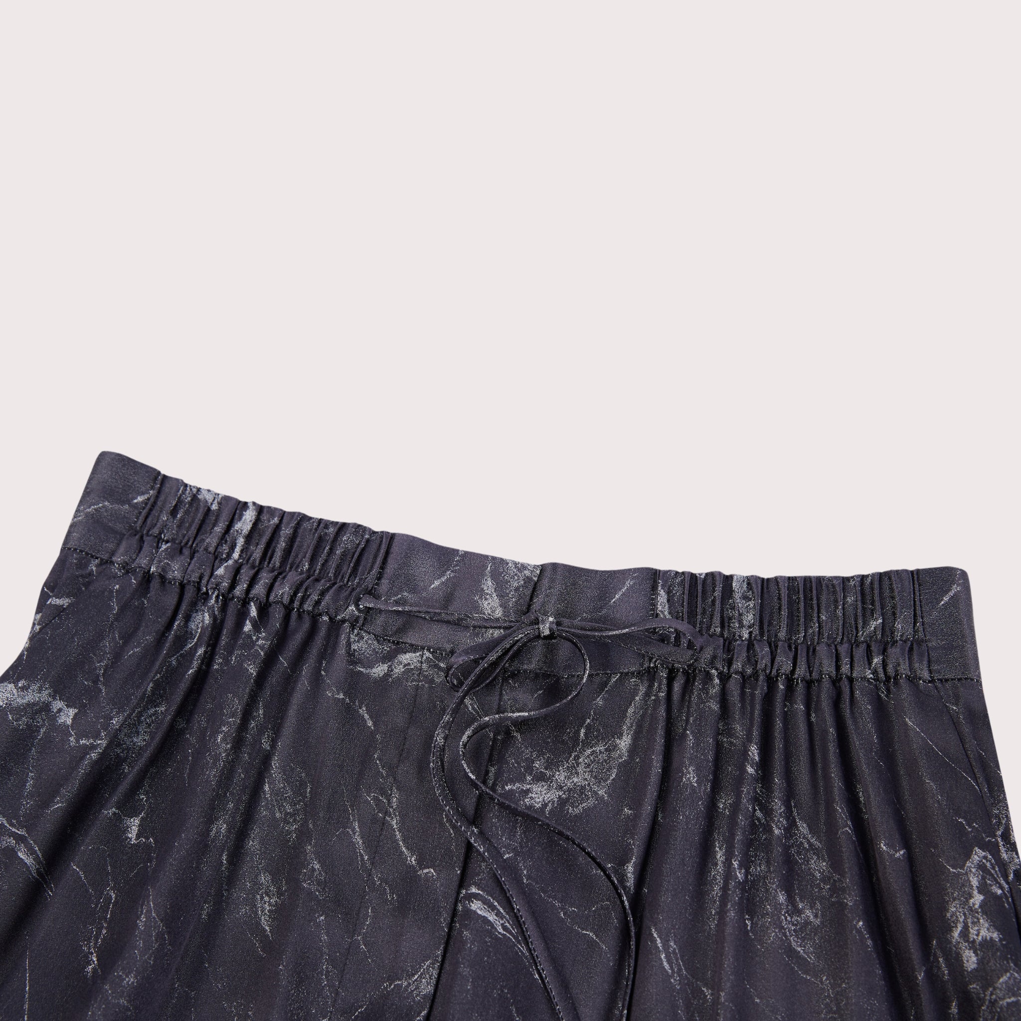 closeup of the waistband detail on silk wide leg pants