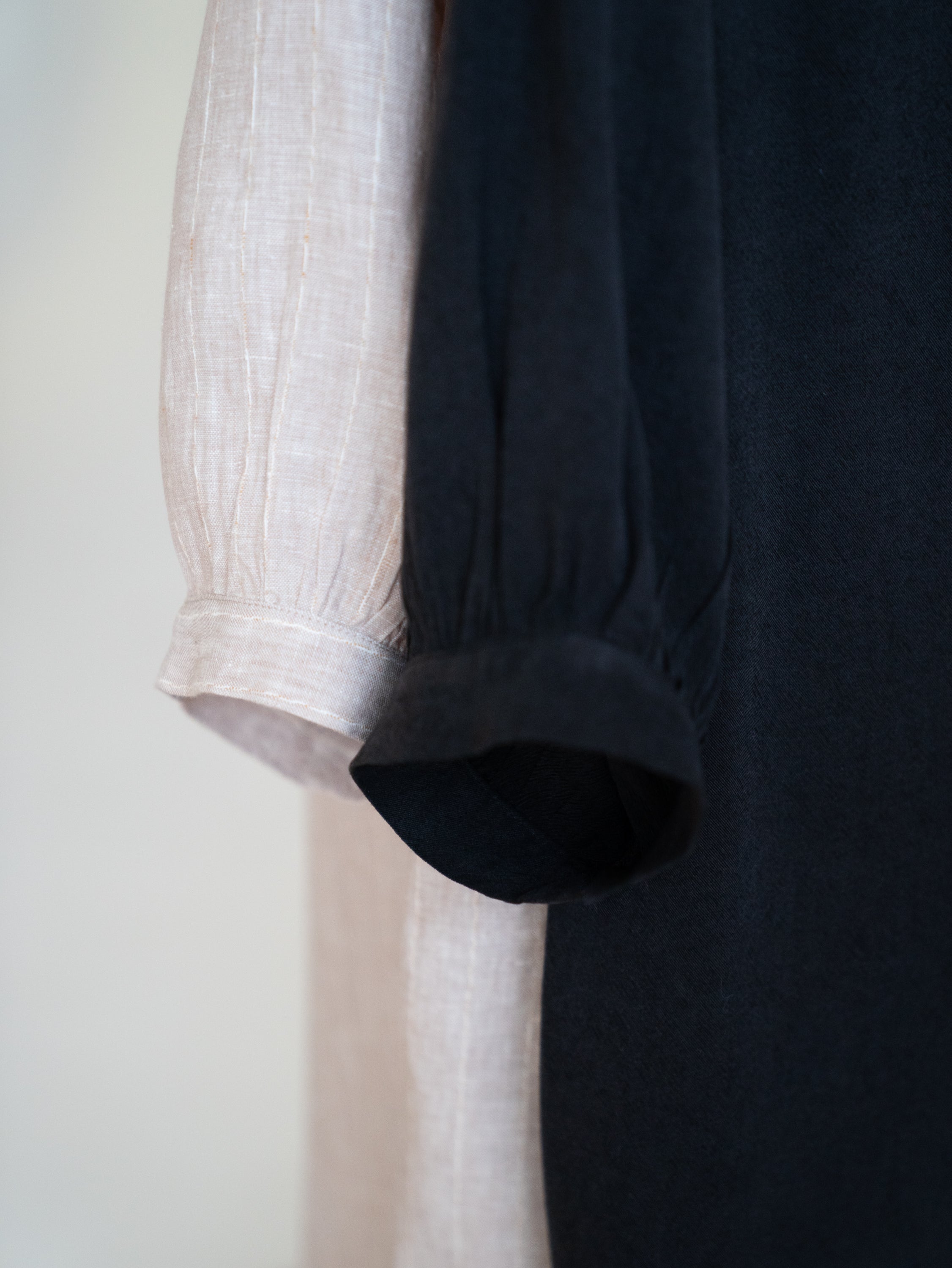 closeup of the puff sleeves on black and beige shirt dresses