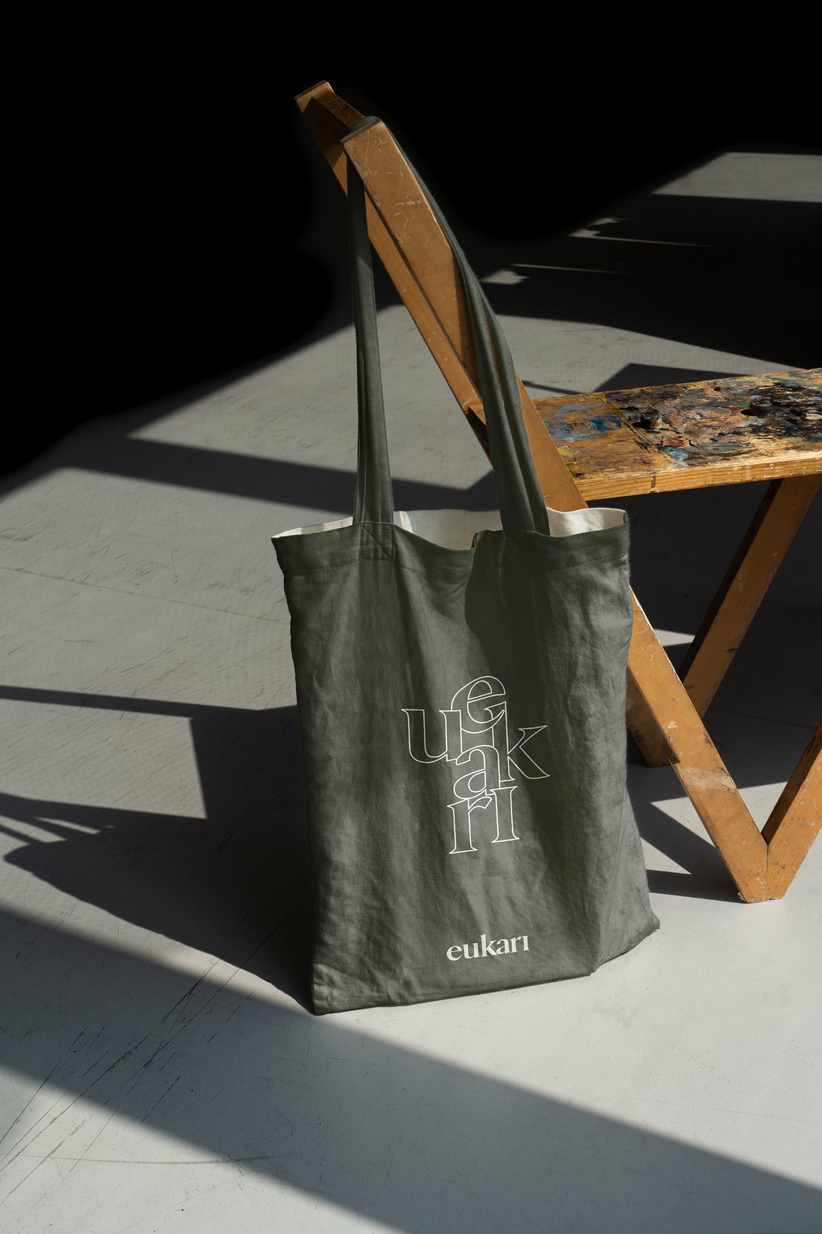 a dark green reusable bag featuring the eukari pattern
