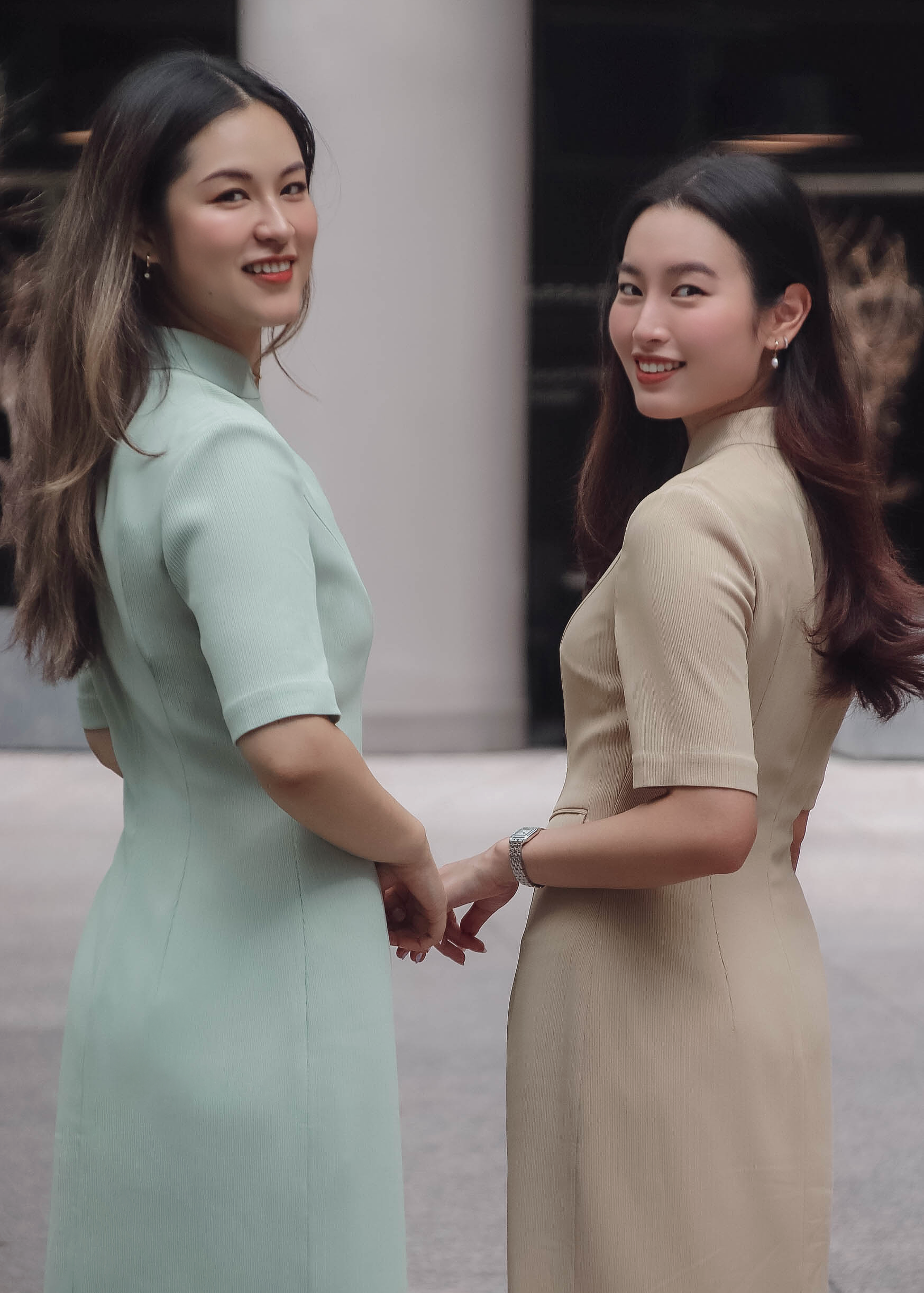 two models standing in mid-sleeve qipaos