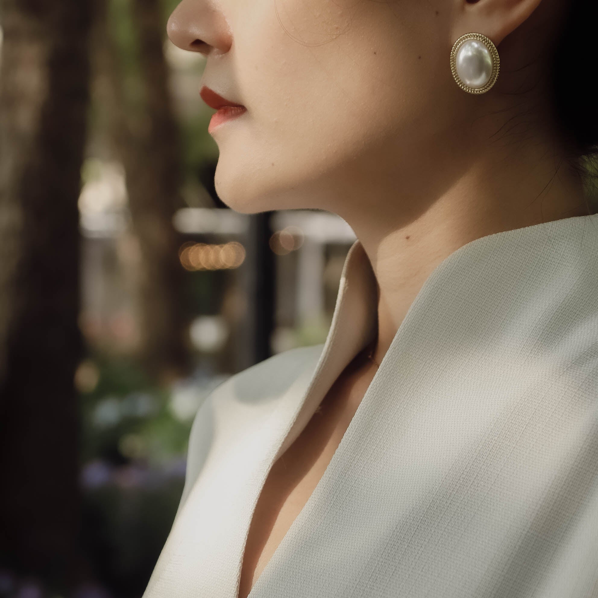 closeup of model in white sleeveless qipao